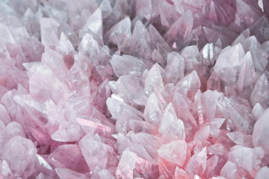 A detailed close-up of rose quartz crystals showcasing their pink hues and translucent nature.